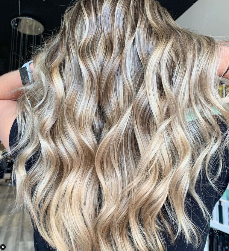 Finely woven blonde pieces blended through wavy hair at HairSocial