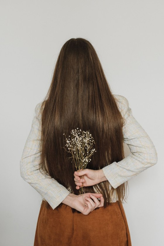 Back view of very long smooth frizz-free brown hair after a keratin smoothing treatment