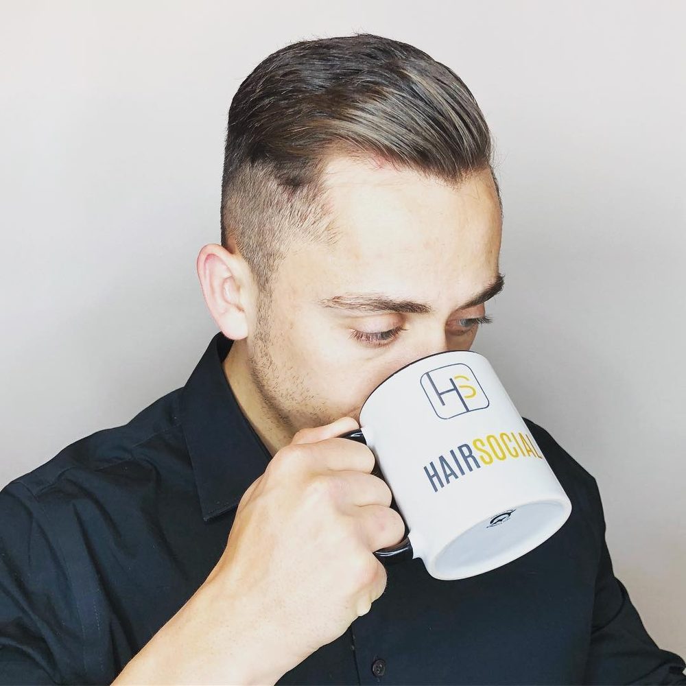 Men’s haircut in Tysons: tapered sides with a side part combed back through the top