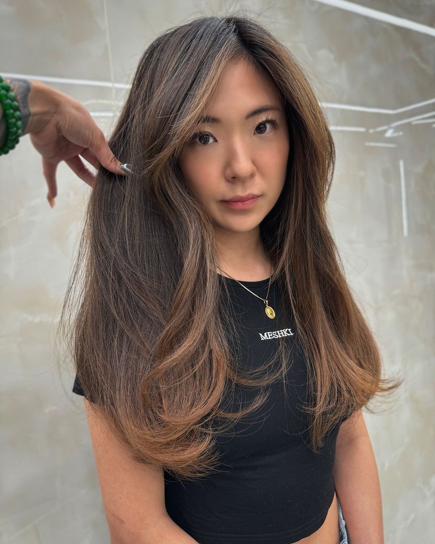 Client with long brunette layers and soft movement at HairSocial
