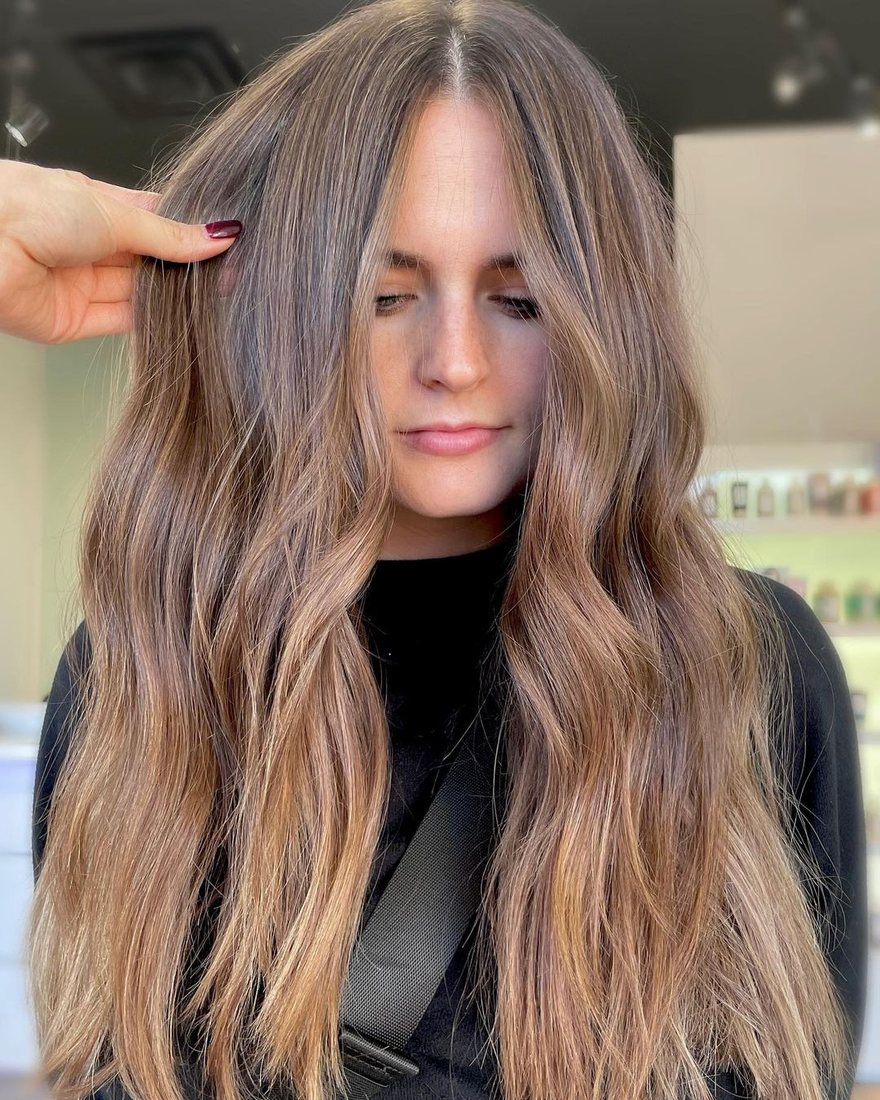 Long lived-in brunette balayage with soft waves at HairSocial